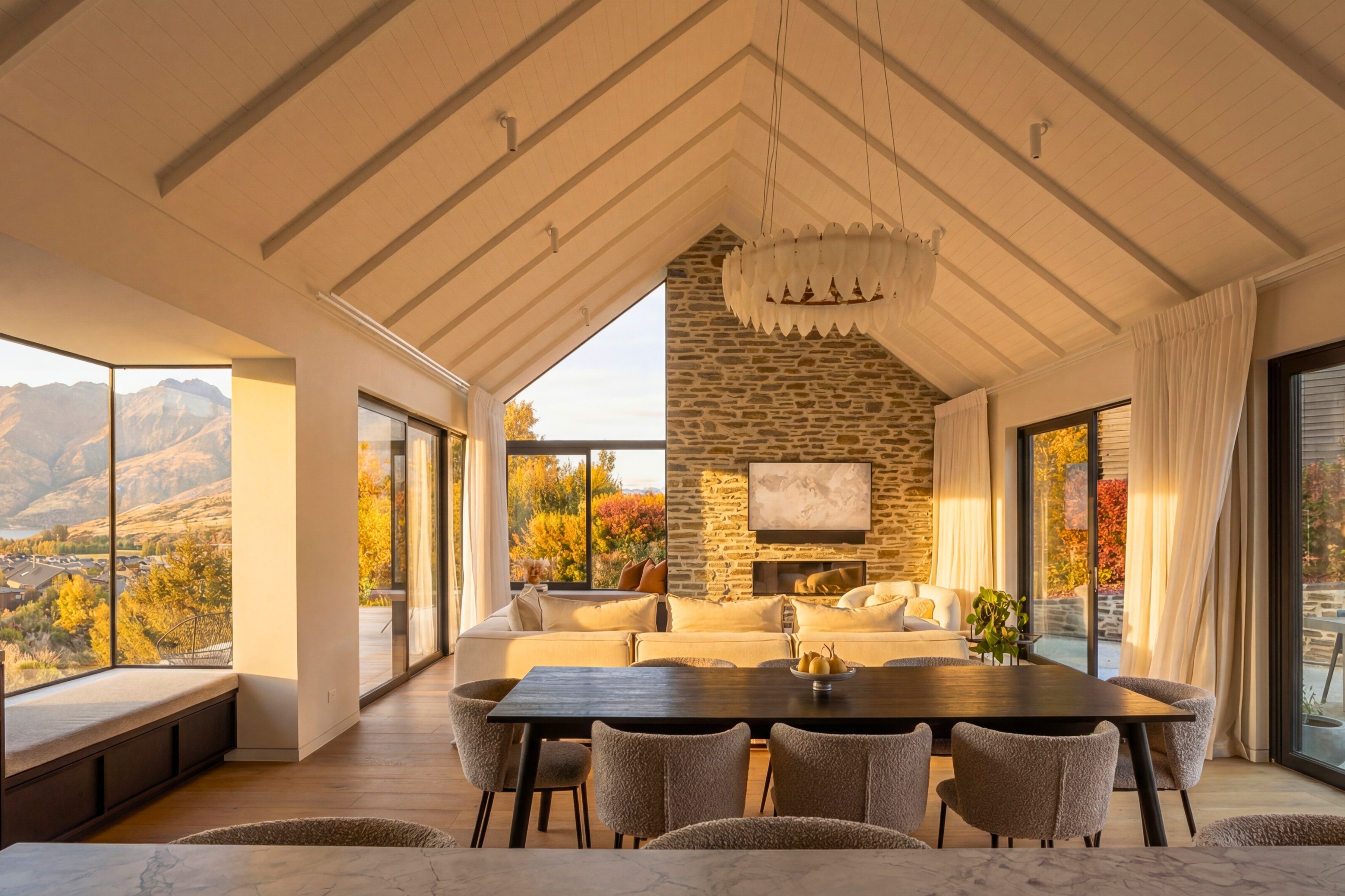 Open-plan kitchen with stone benchtops, vaulted ceiling and window seat